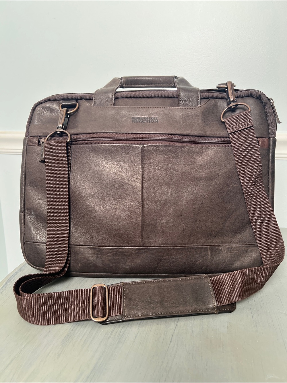 Kenneth Cole Reaction Men’s Brown Leather Briefcase. Storage and trolley strap.